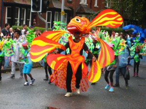 Yellow and orange costume which lit up the parade at the Leeds Carnival. Photo by Mick Burton, continuous line artist.