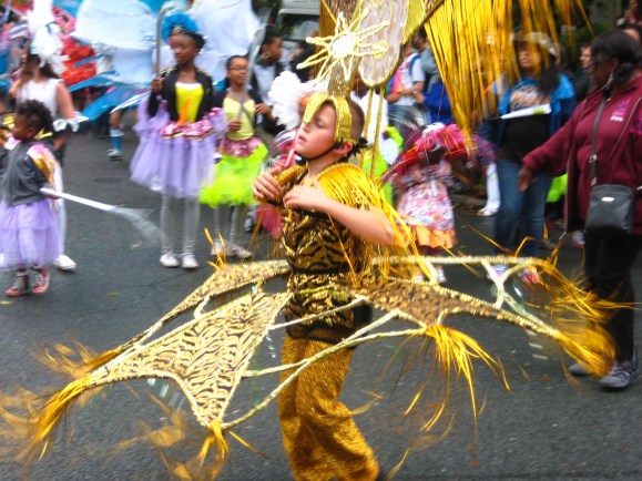 Gold costume at the Leeds Carnival. Photo by Mick Burton, continuous line artist.
