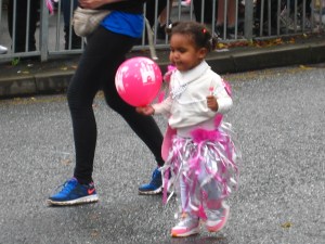 Child with balloon in Leeds Carnival parade. Photo Mick Burton, continuous line artist.
