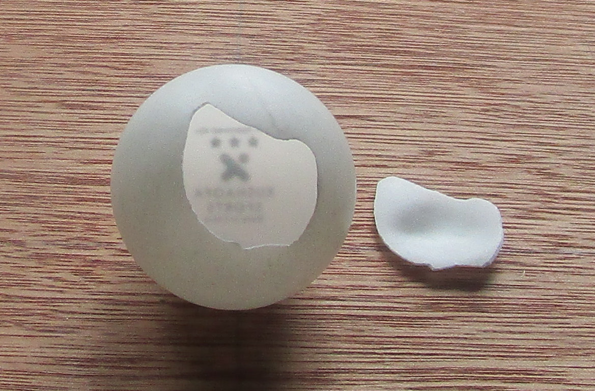 Second broken plastic table tennis ball.